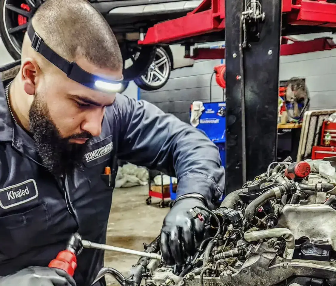Khaled fixing a car engine
